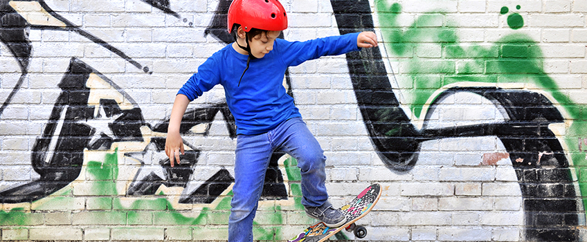 Young boy skateboarding in jeans