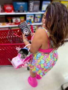 Modern Gen Z mother buying a board game at Target, representing everyday consumer behavior and brand influence
